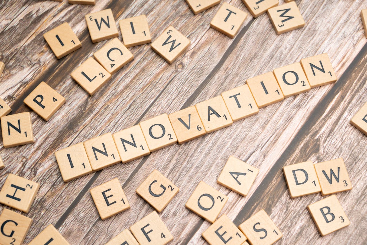 Creative display of 'Innovation' spelled with wooden letter tiles on a wooden surface.