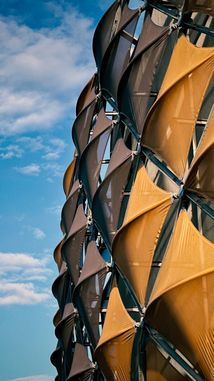 Close-up of a modern architectural facade with dynamic patterns and a clear sky.