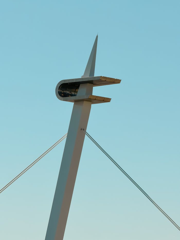 Close-up of a sleek, modern architectural structure with a minimalist design set against a clear blue sky.